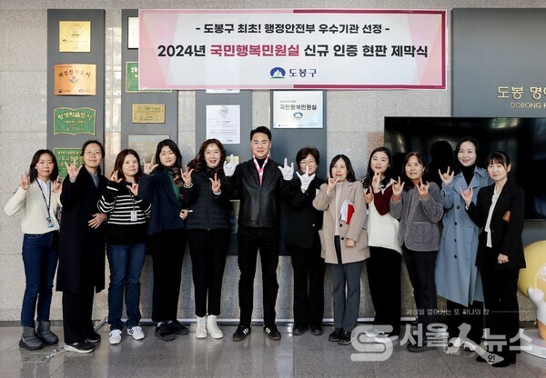 ▲오언석 도봉구청장이 구 직원, 구민 등과 함께 국민행복민원실 현판 제막식을 가진 뒤 기념 촬영하고 있다(2024. 12. 27. 도봉구청 1층 북문 입구)